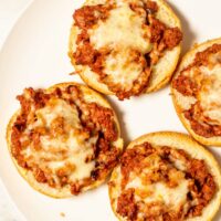 Top view on a large plate with four Pizza Burgers.