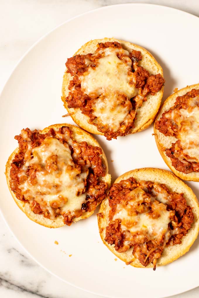 Top view on a large plate with four Pizza Burgers.