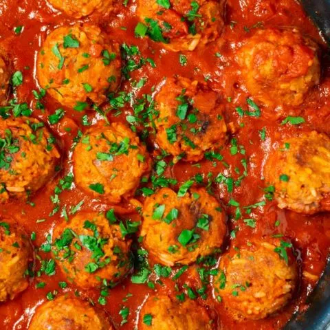 Closeup of Porcupine Meatballs in a pan.