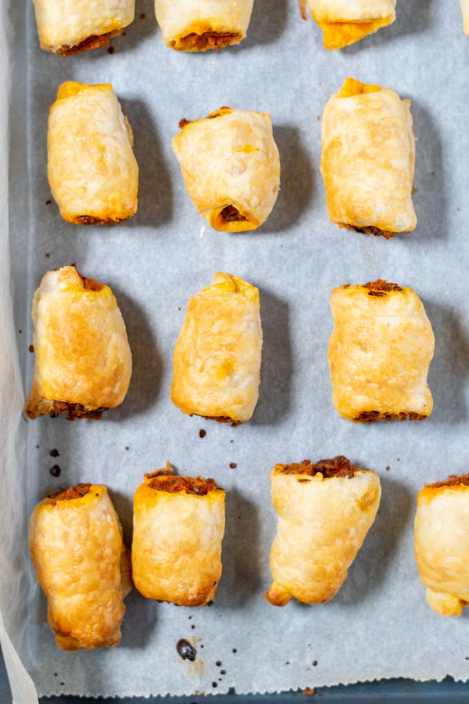 Top view on a baking sheet with Sausage Rolls after baking.