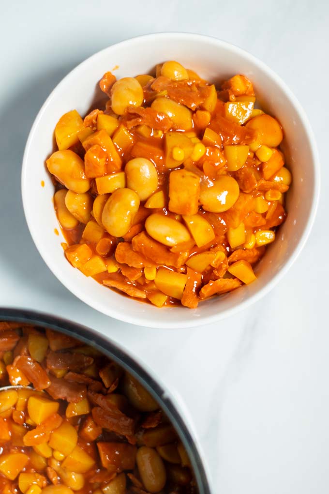 A portion of Brunswick Stew in a white bowl.