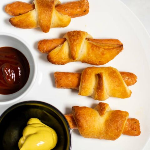 Four Pigs in a Blanket on a plate.