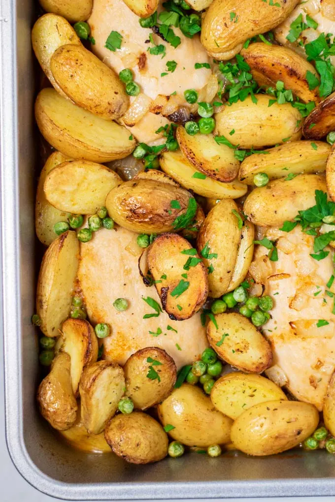 Closeup of Chicken Vesuvio in a baking pan.