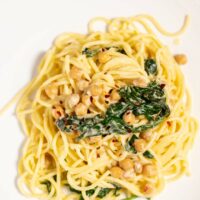 Top view on a portion of Chickpea Pasta, served on a white plate.