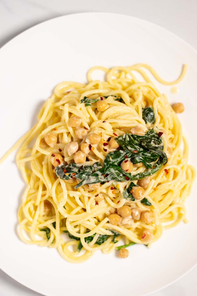 Top view on a portion of Chickpea Pasta, served on a white plate.