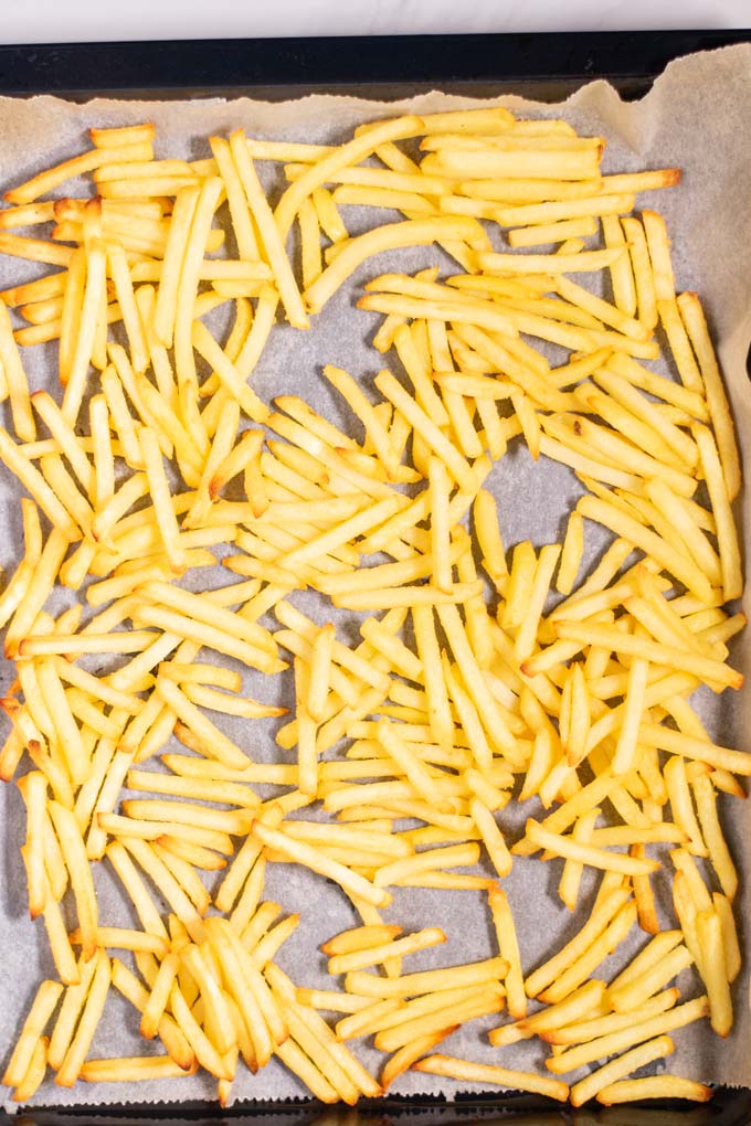 Fries on a baking sheet after baking.