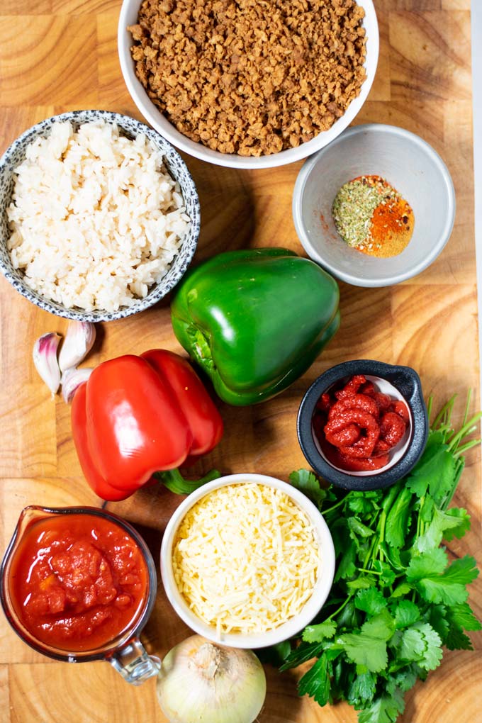 Ingredients needed for making Stuffed Pepper Casserole are collected on a board.