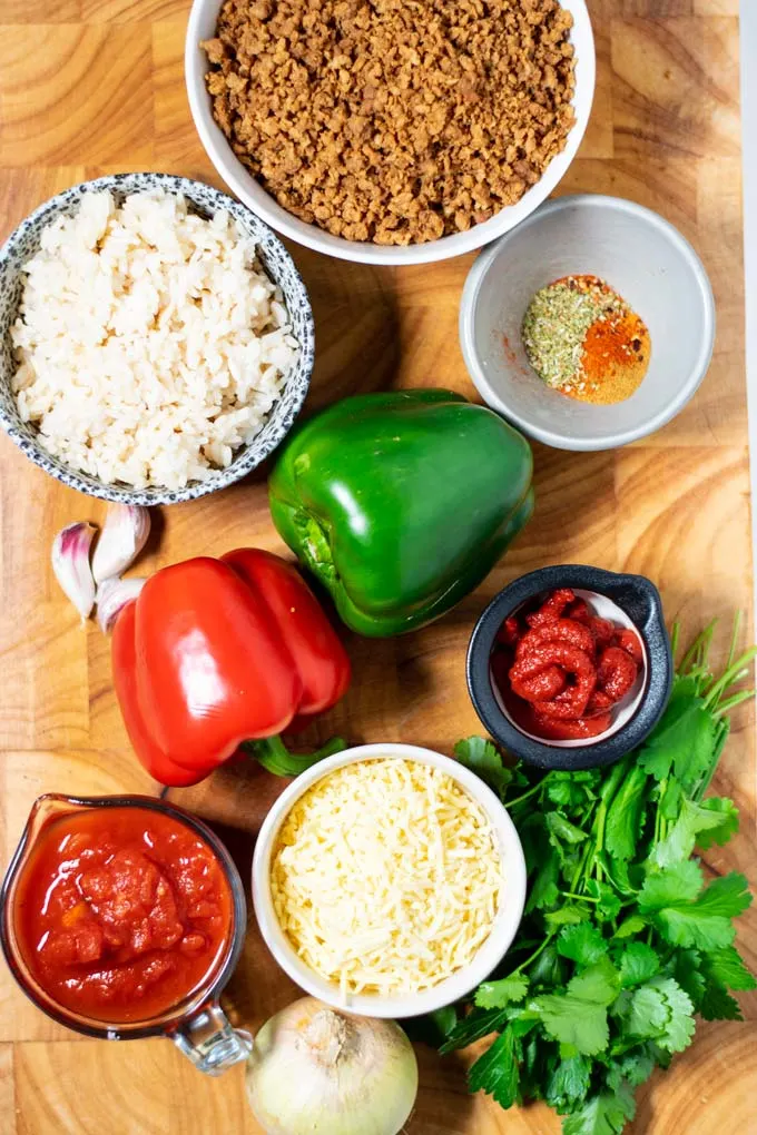 Ingredients needed for making Stuffed Pepper Casserole are collected on a board.