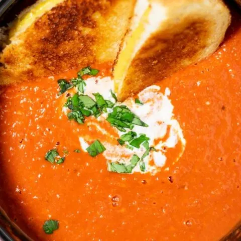 Top view of a large pot of the Tomato Soup, served with Grilled Cheese Sandwich.
