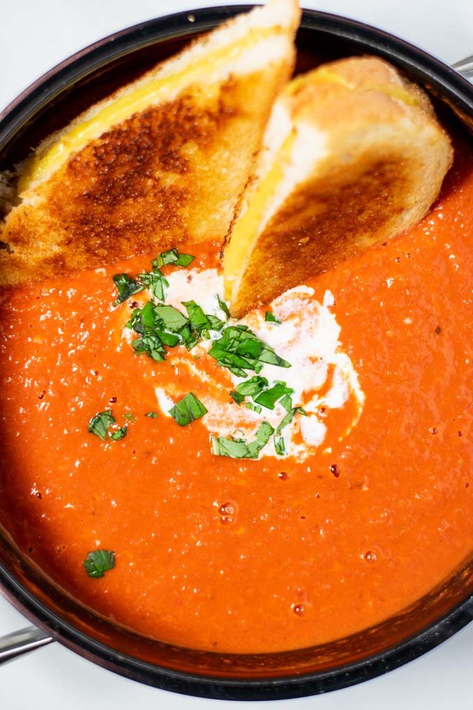Top view of a large pot of the Tomato Soup, served with Grilled Cheese Sandwich.