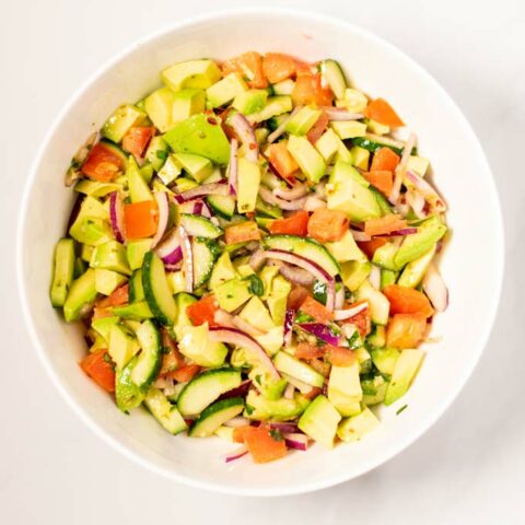 Top view of a large mixing bowl with Avocado Salad.