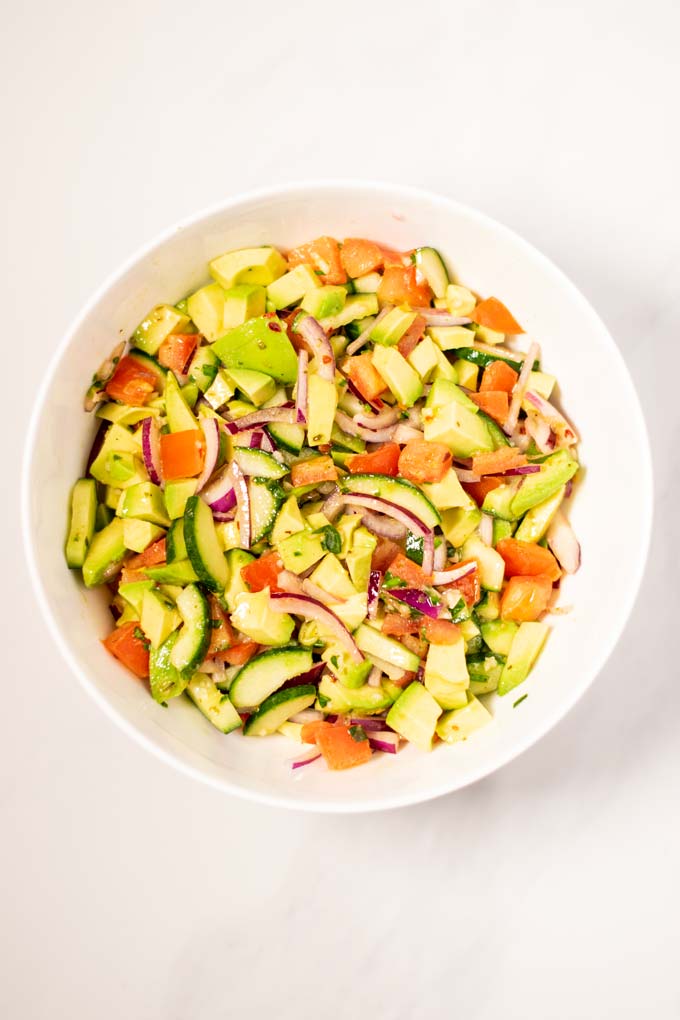 Top view of a large mixing bowl with Avocado Salad.