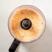 Top view on the bowl of a food processor after blending all ingredients.