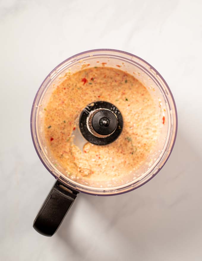 Top view on the bowl of a food processor after blending all ingredients.