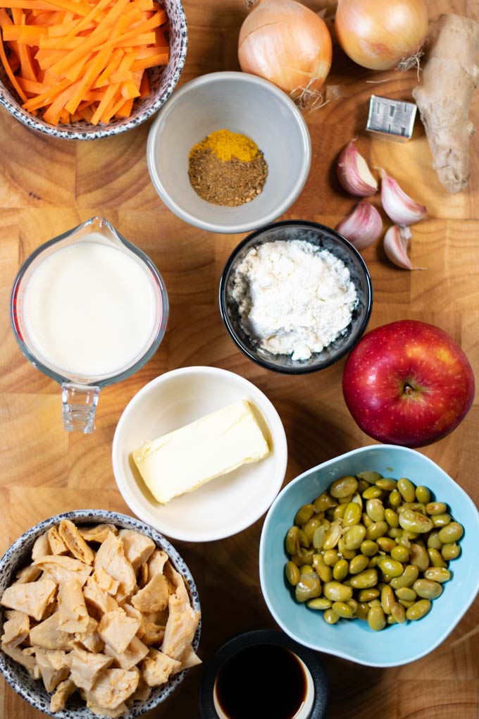 Ingredients needed to make Japanese Curry are collected before preparation on a wooden board.