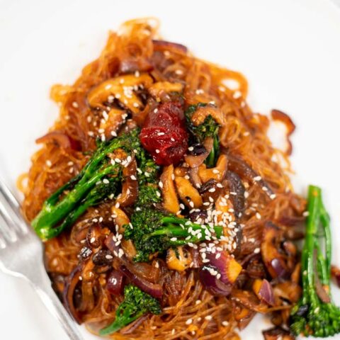 Portion of Japchae served on a white plate.