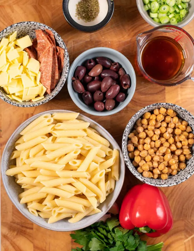 Ingredients for Antipasto Salad are collected on a board.