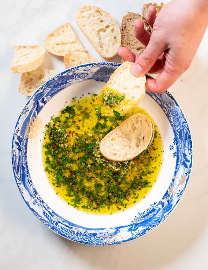 Bread is dipped into the oil and held.