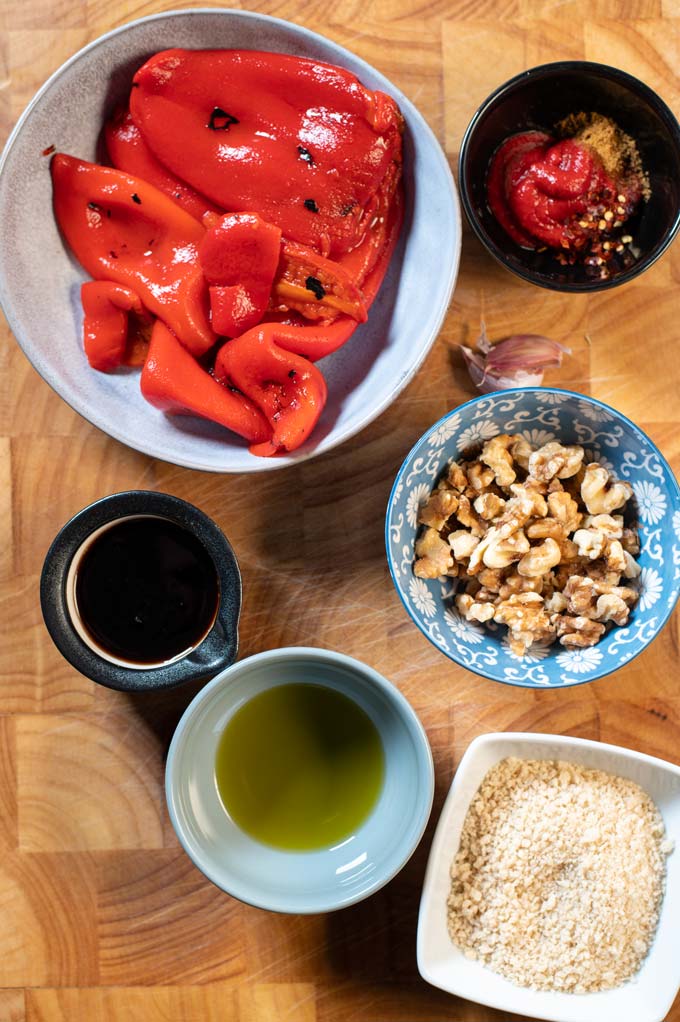 Ingredients needed to make Muhammara are collected on a board.