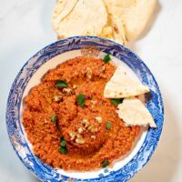 Collage of two photos of Muhammara with recipe title text.