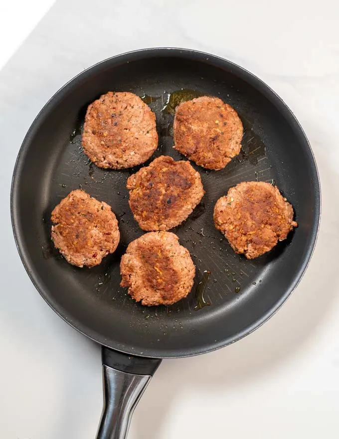 Ready fried Sausage Patties in a frying pan.
