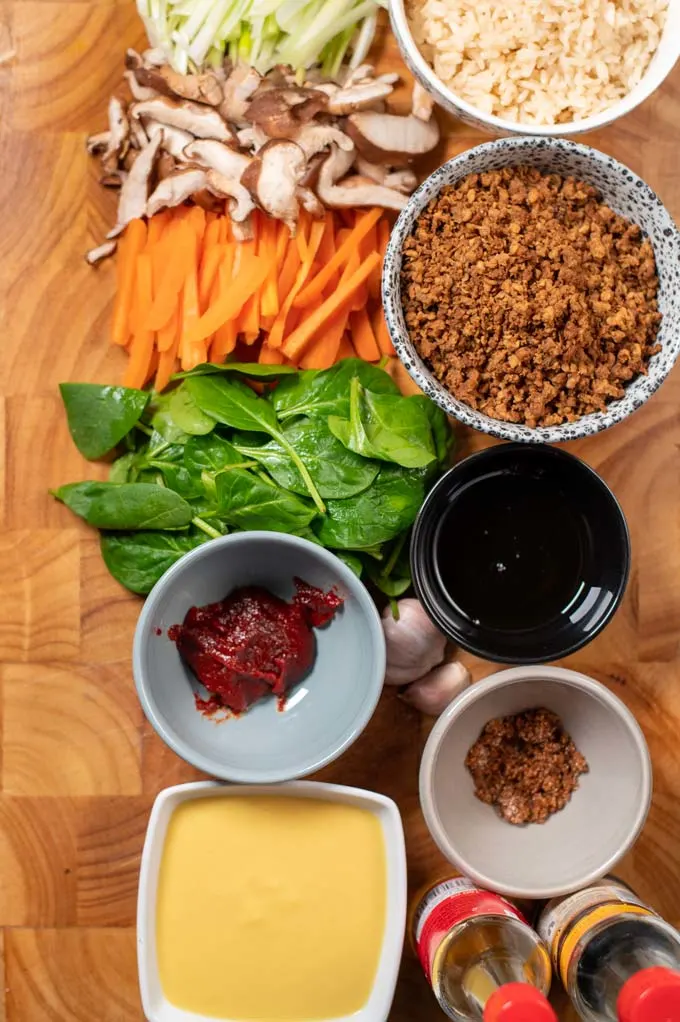 Ingredients needed for making Bibimbap collected on a board before preparation.
