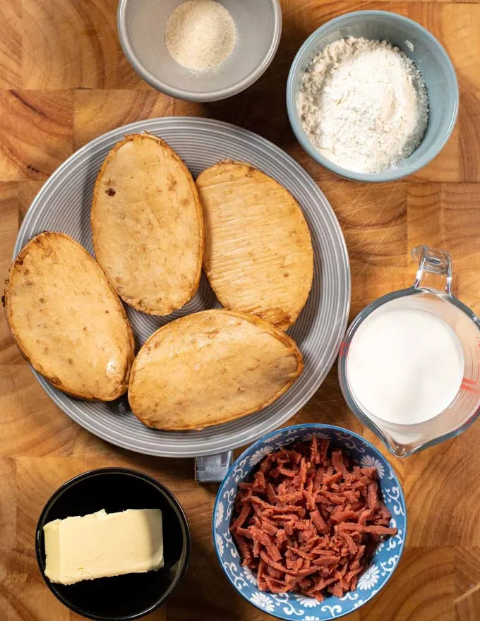 Ingredients needed to make Smothered Chicken on a board.