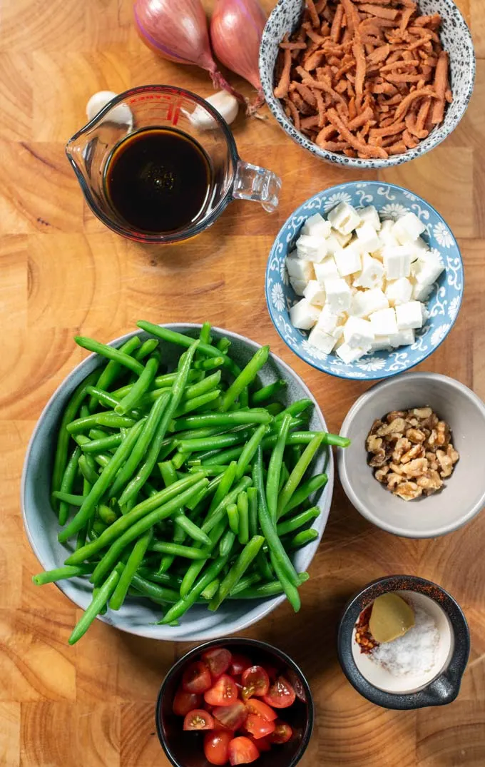 Ingredients needed to make Green Bean Salad are collected on a board.