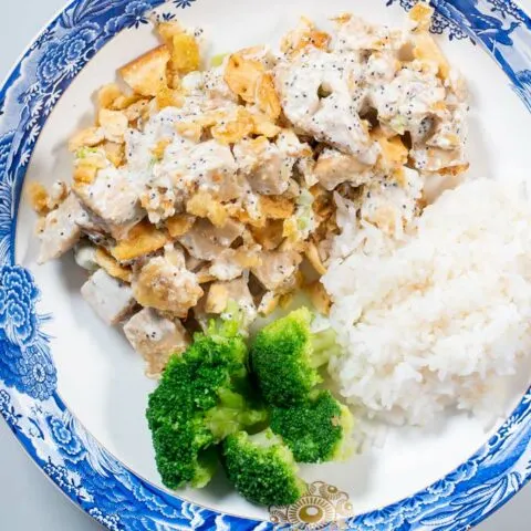 Closeup of a portion of Poppy Seed Chicken served with rice and broccoli.