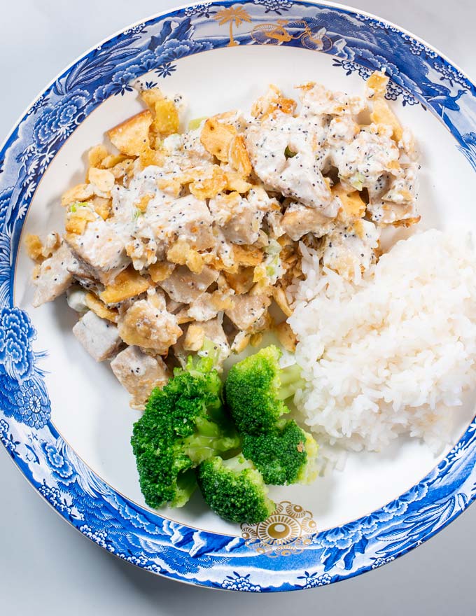 Closeup of a portion of Poppy Seed Chicken served with rice and broccoli.