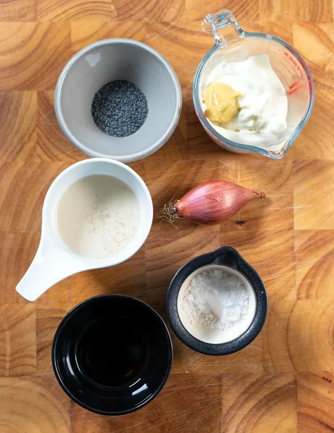 Ingredients needed to make Poppy Seed Dressing are collected on a board.