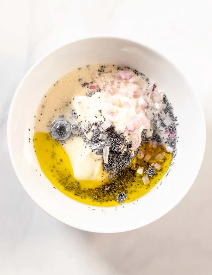 All ingredients for of the Poppy Seed Dressing are given into a white mixing bowl.