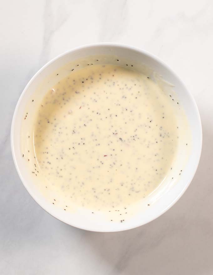 Top view of a mixing bowl with the mixed Poppy Seed Dressing.