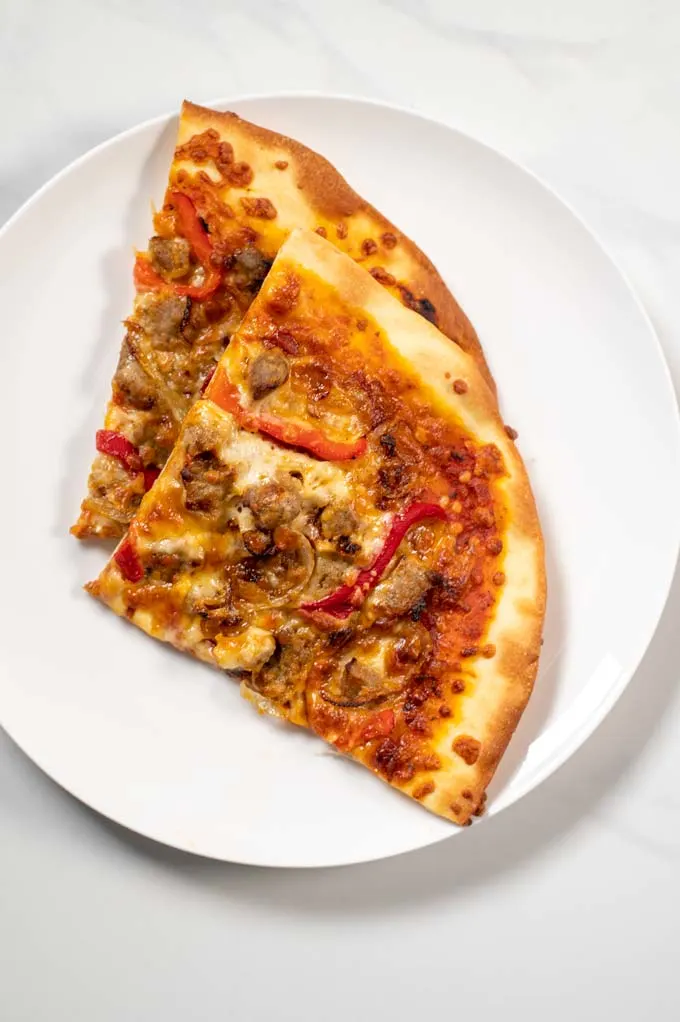 Two slices of Sausage Pizza served on a plate.