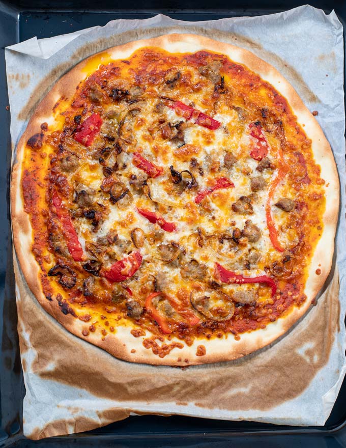 Top view of the ready Sausage Pizza coming out of the oven.