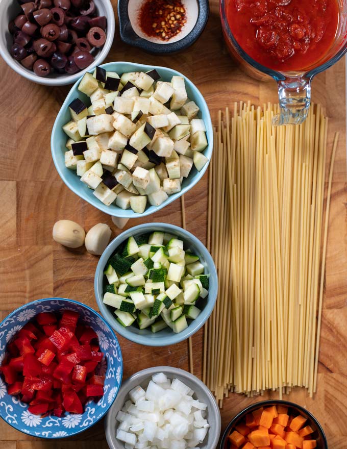 Ingredients needed for making Vegetable Spaghetti are collected on a board.