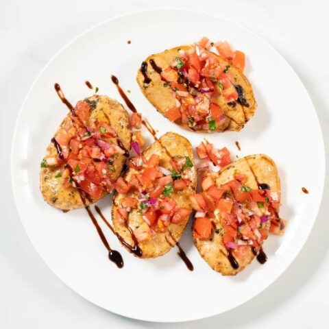 A plate with four Bruschetta Chicken.