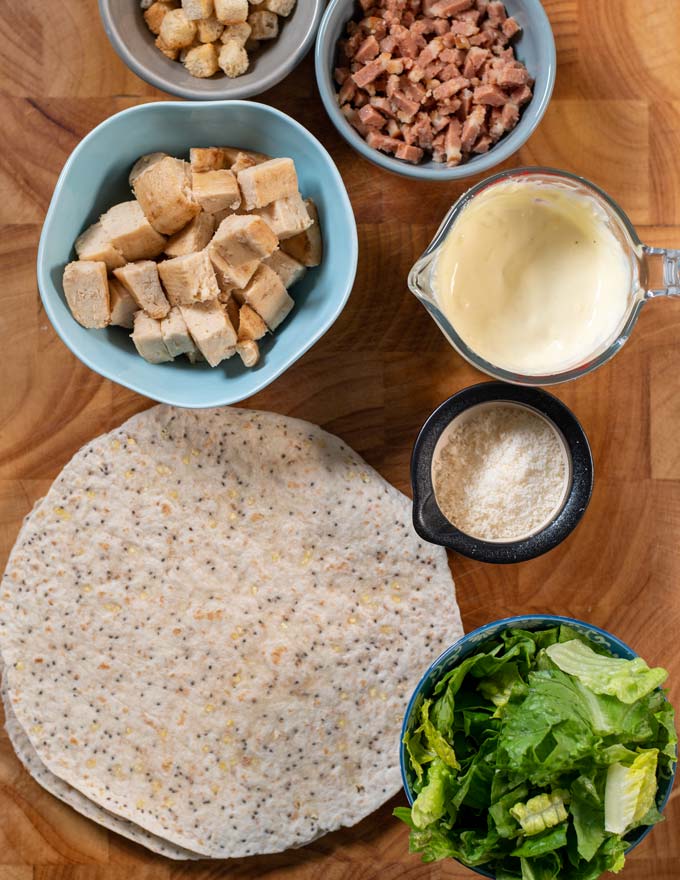 Ingredients needed to make Chicken Caesar Wraps are collected before preparation.