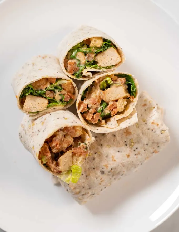 Open cut serving of Chicken Caesar Wraps.