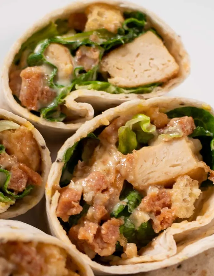 Closeup on a open cut Chicken Caesar Wrap.