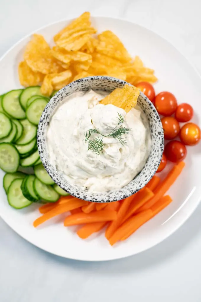 Closeup on a small bowl of Dill Dip with chips.