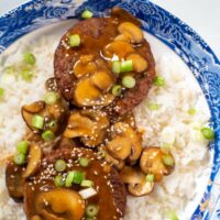 Closeup on a serving of Loco Moco, garnished with sesame seeds.