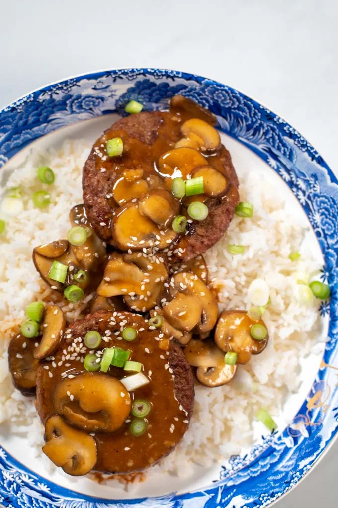 Closeup on a serving of Loco Moco, garnished with sesame seeds.