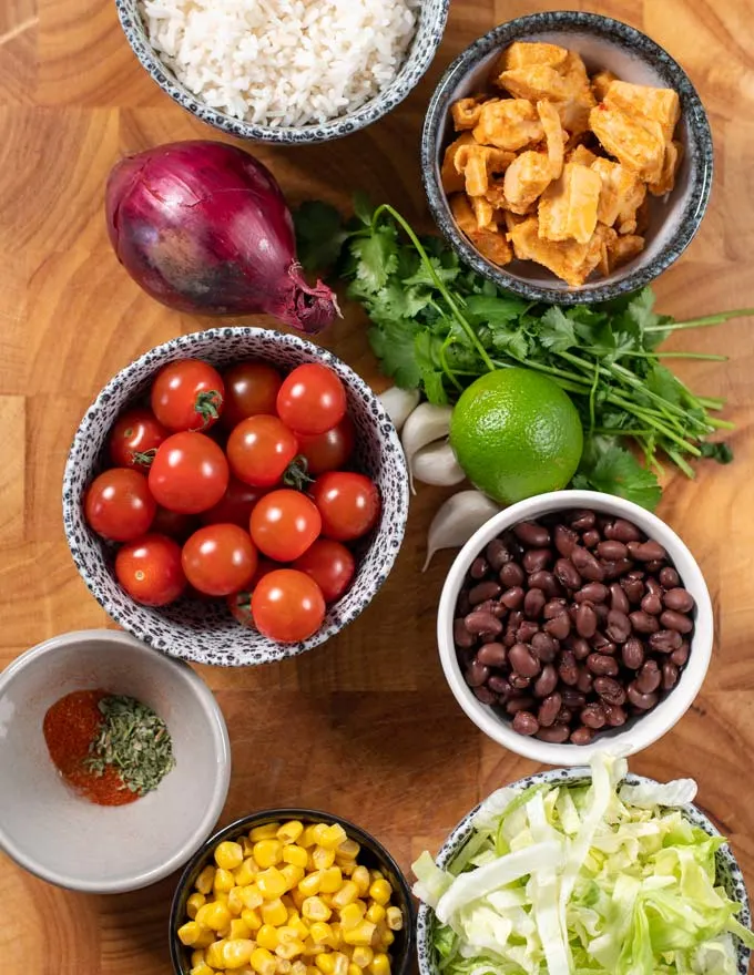 Ingredients needed to make Burrito Bowl on a board.