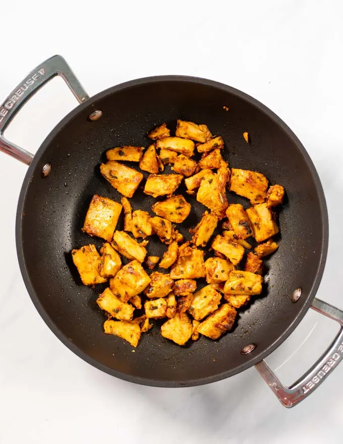 Top view of a frying man with marinated chicken.