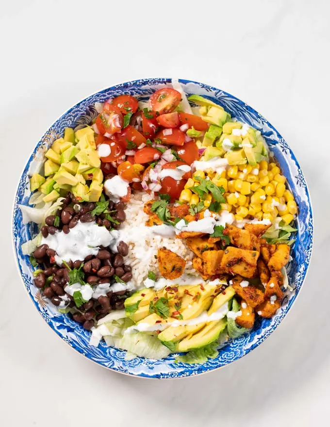 Serving of Burrito Bowl sprinkled with sauce.