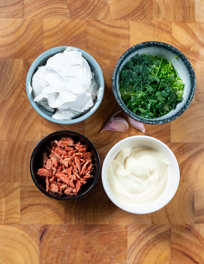 Ingredients needed for making Cream Cheese Dip collected on a board.