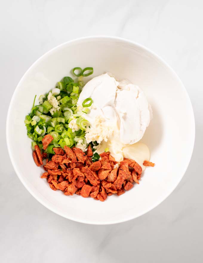 Top view of a mixing bowl with the ingredients for the Cream Cheese Dip.