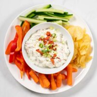Cream Cheese Dip is served with chips and veggies.