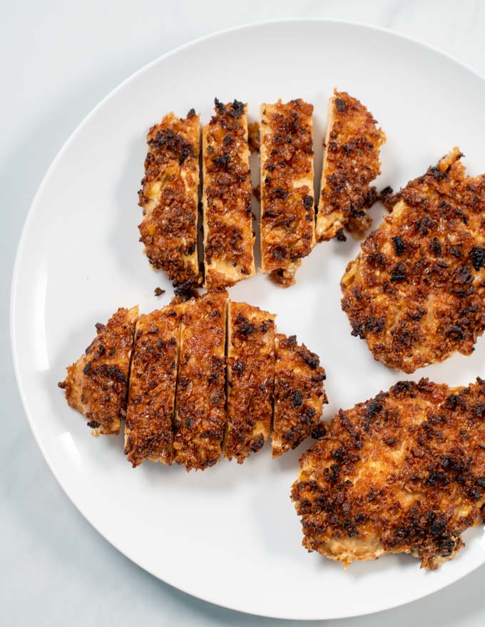 View of four pieces of Crispy Chicken on a serving plate.